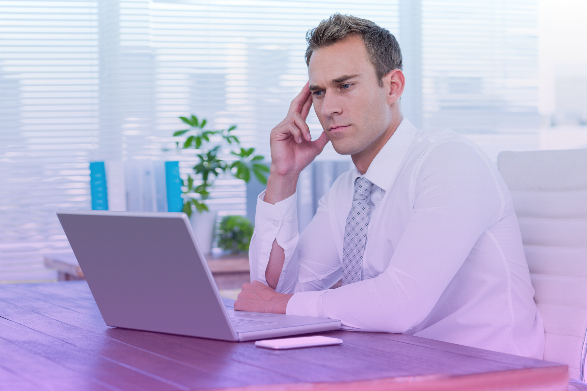 A person with a worried or frustrated expression looking at a legal document, illustrating prenup-related anxiety.