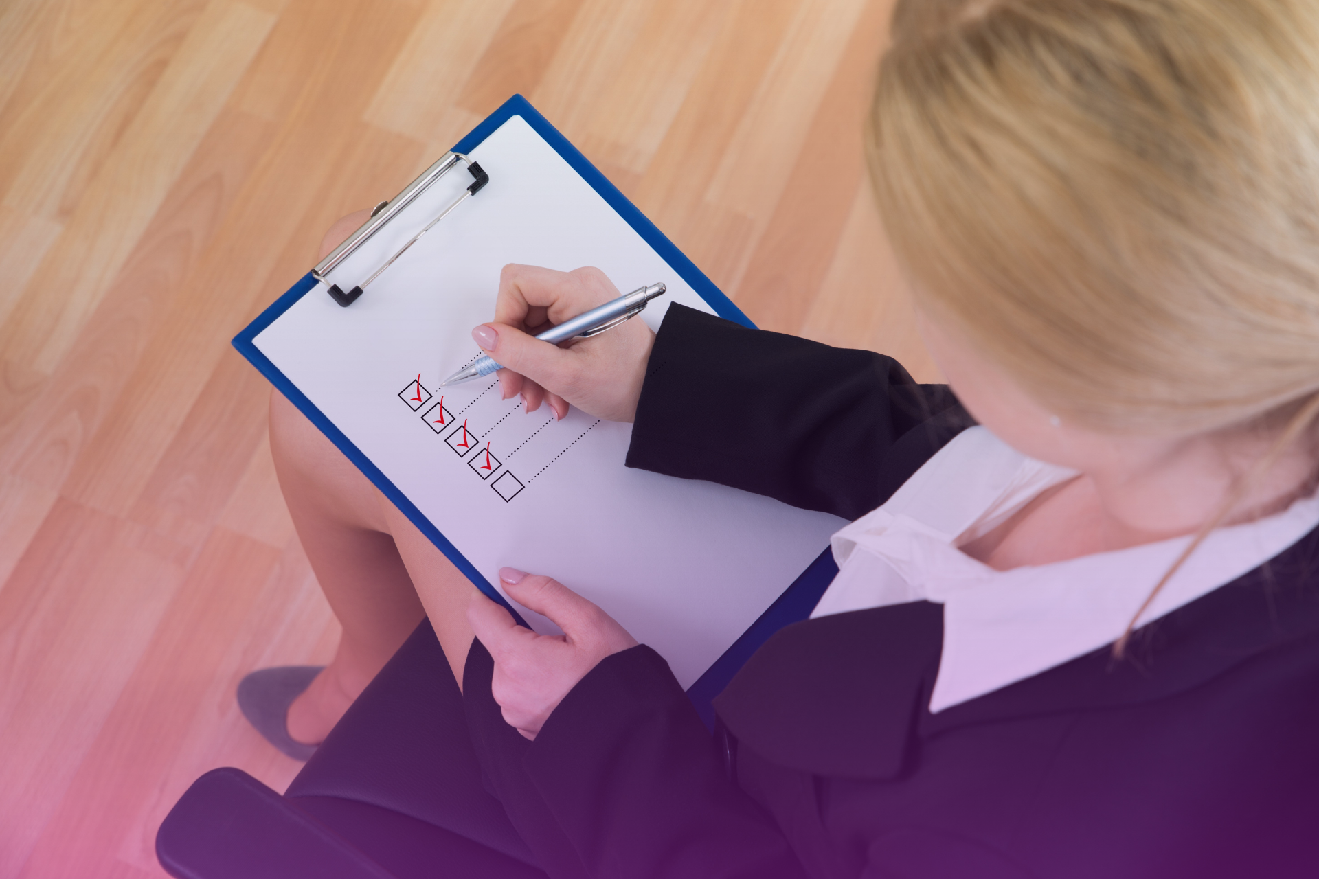 A hand holding a pen, marking items on a legal checklist, symbolizing attention to legal requirements.