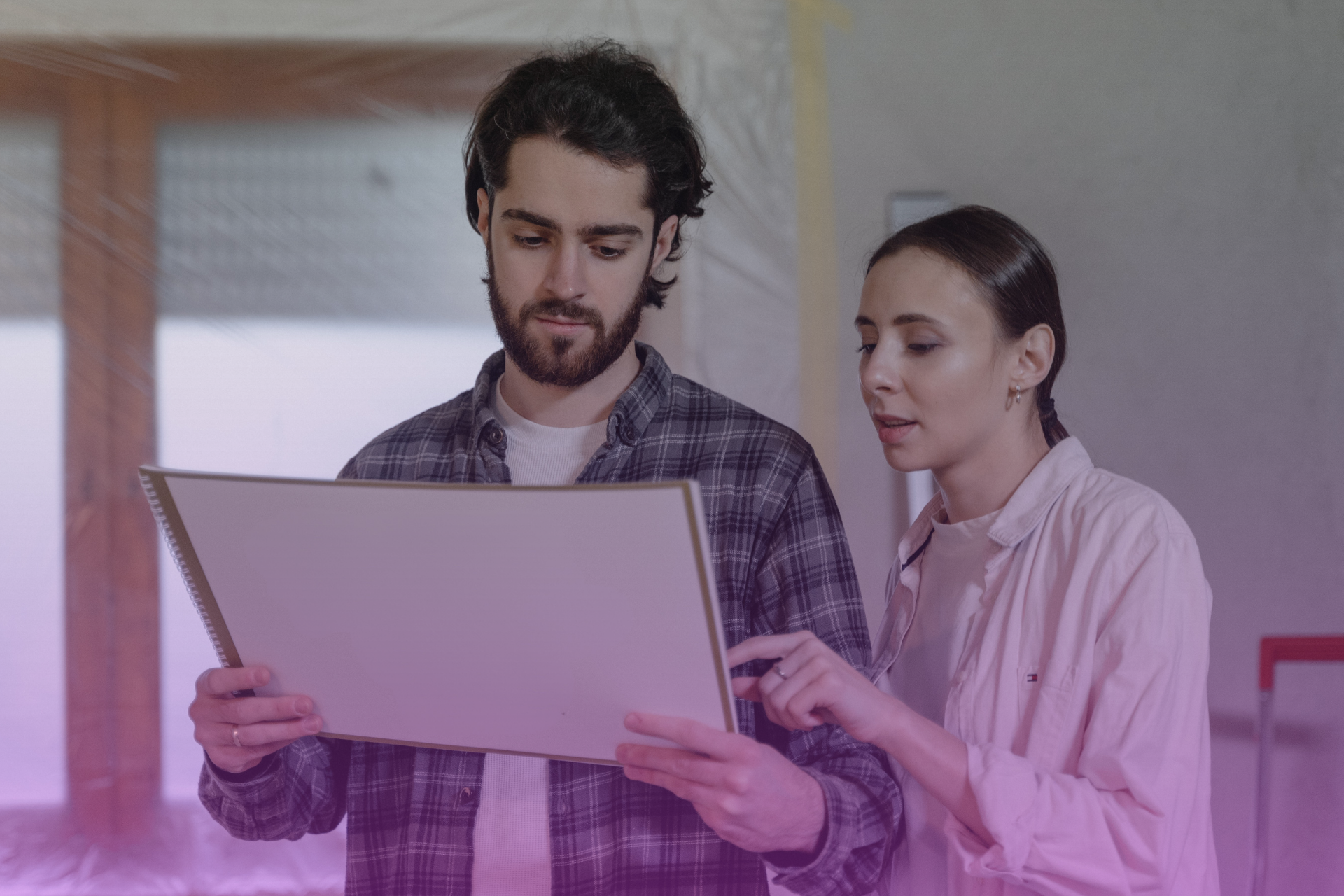A couple calmly discussing financial matters in their home, emphasizing the importance of open communication to achieve fair outcomes