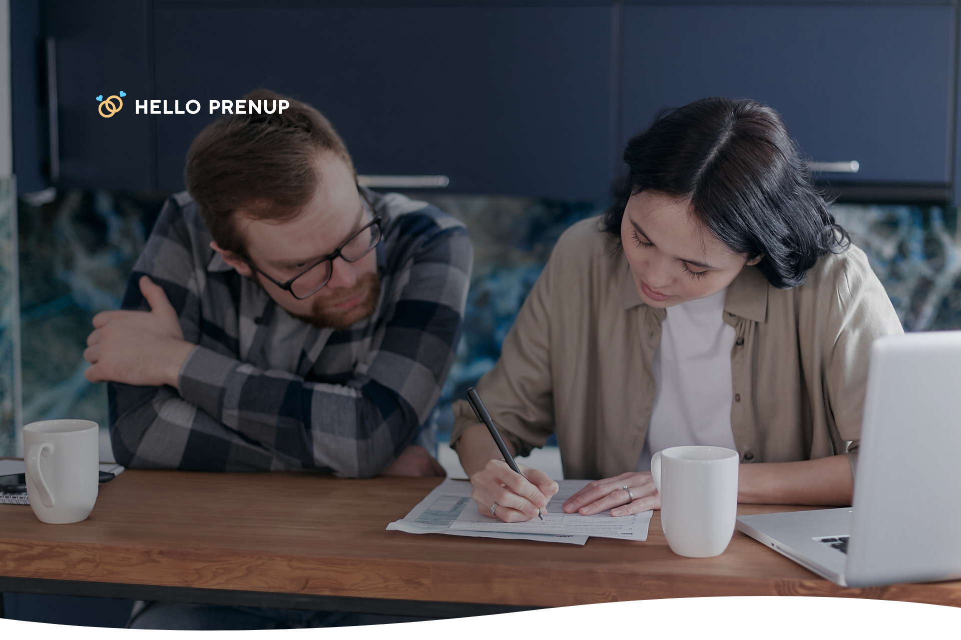 couple-filling-out-form-together A couple sitting at a desk, with a lawyer overseeing as they sign a prenuptial agreement, emphasizing professional drafting and understanding.