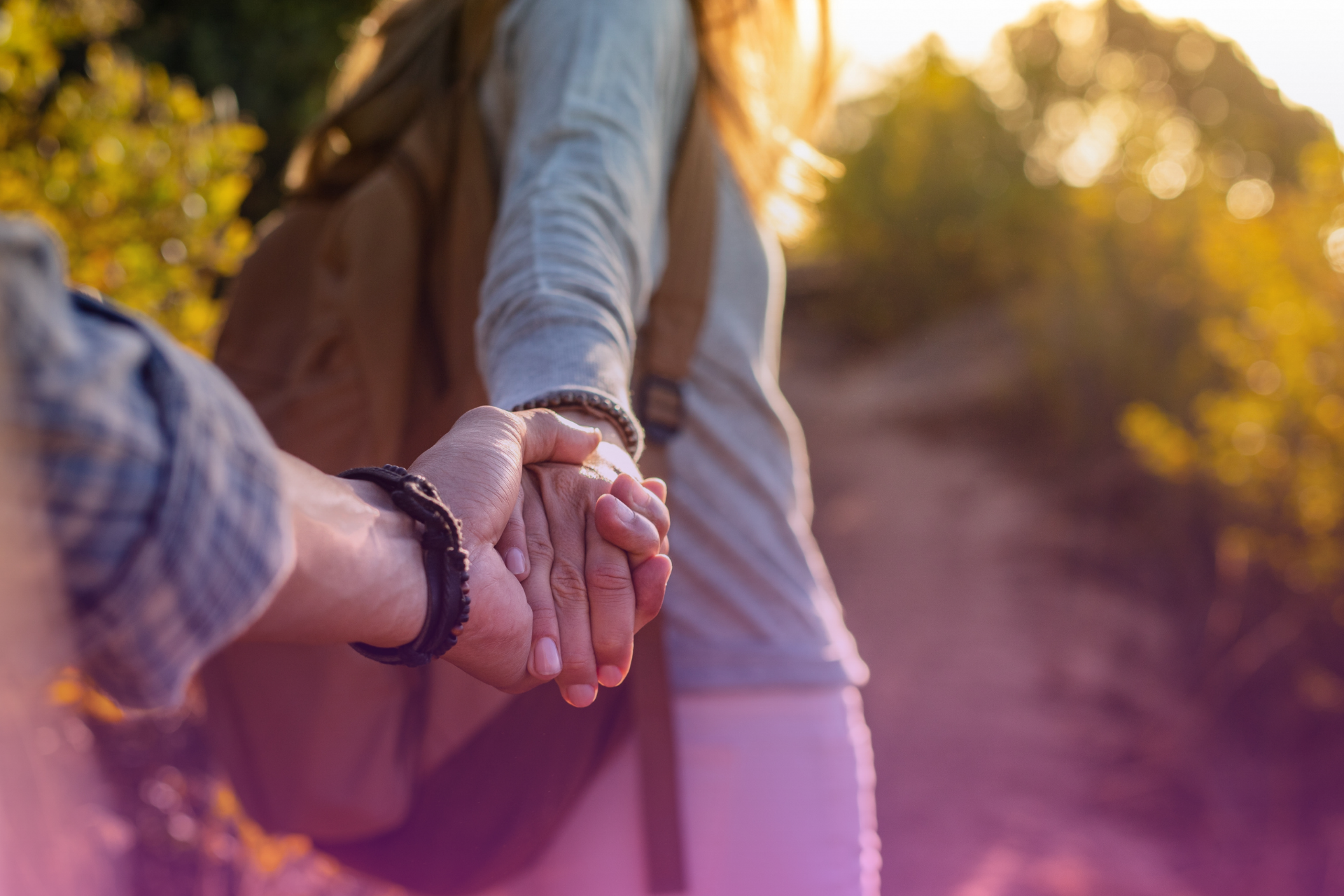 A couple holding hands over a financial chart or document, symbolizing unified financial decisions and emotional support.