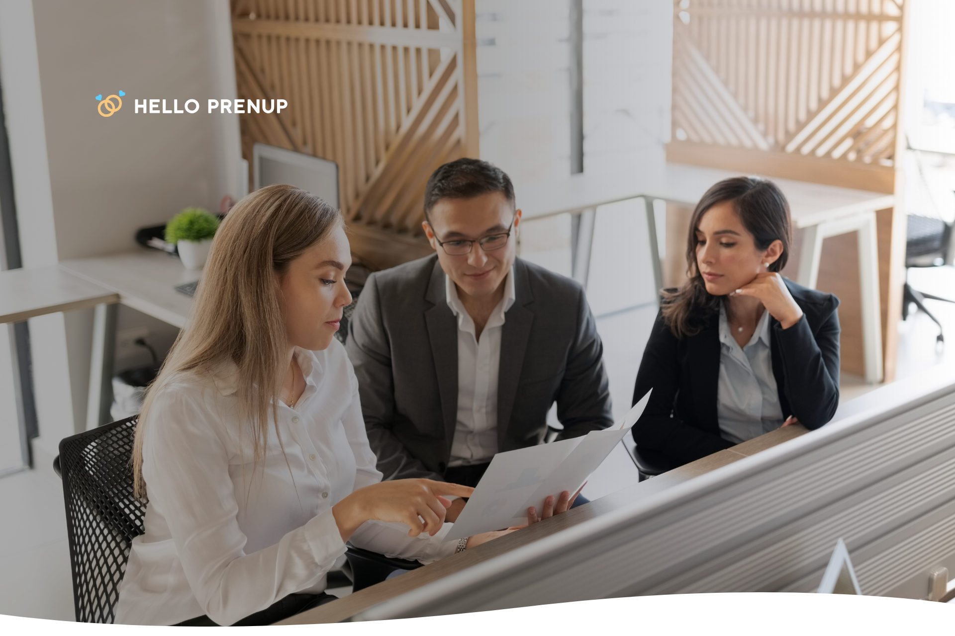 A couple sitting at a desk, reviewing legal documents with an attorney, illustrating professional legal guidance.