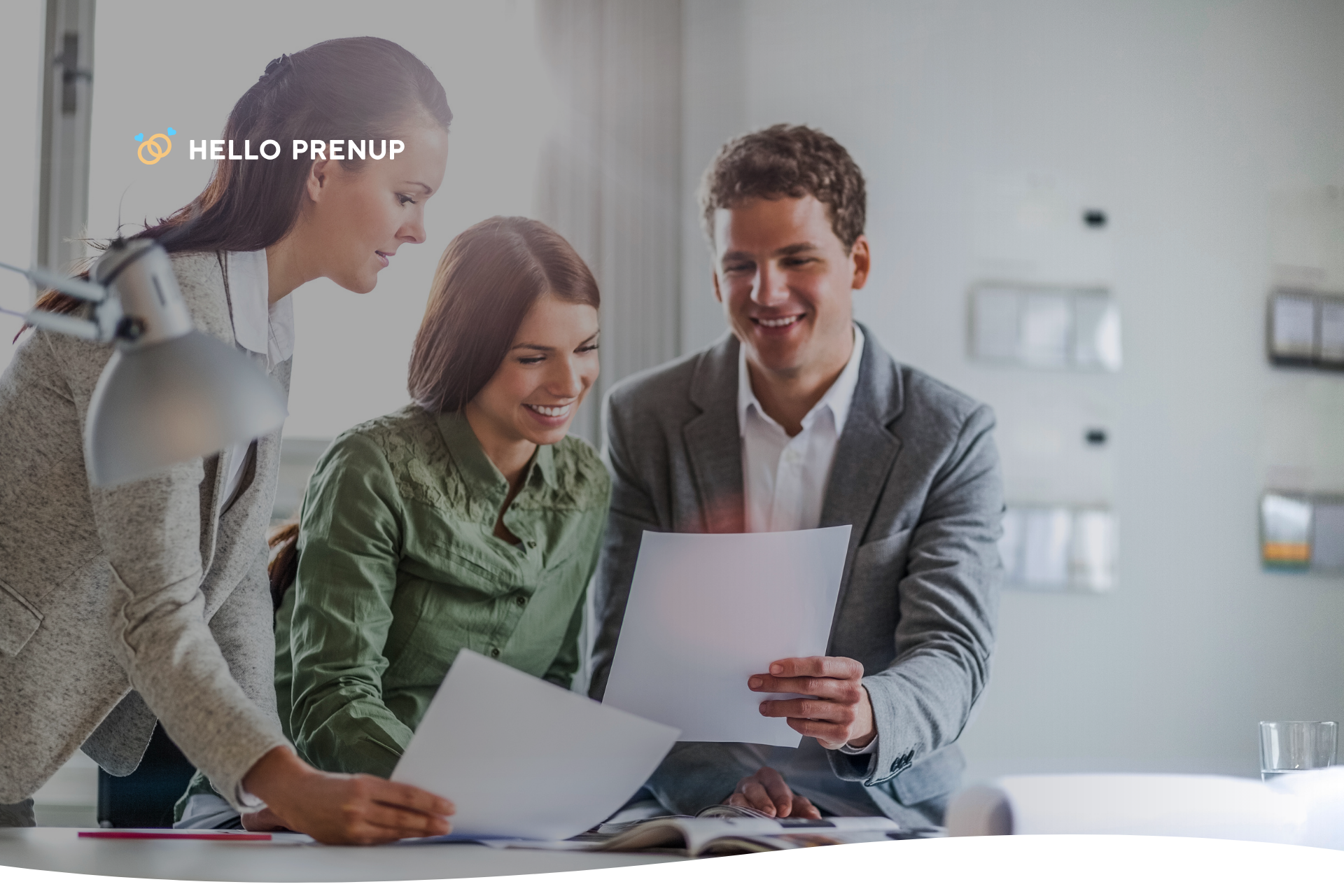 couple-reviewing-documents-with-attorney A couple sitting at a desk, reviewing legal documents with an attorney, illustrating professional legal guidance.