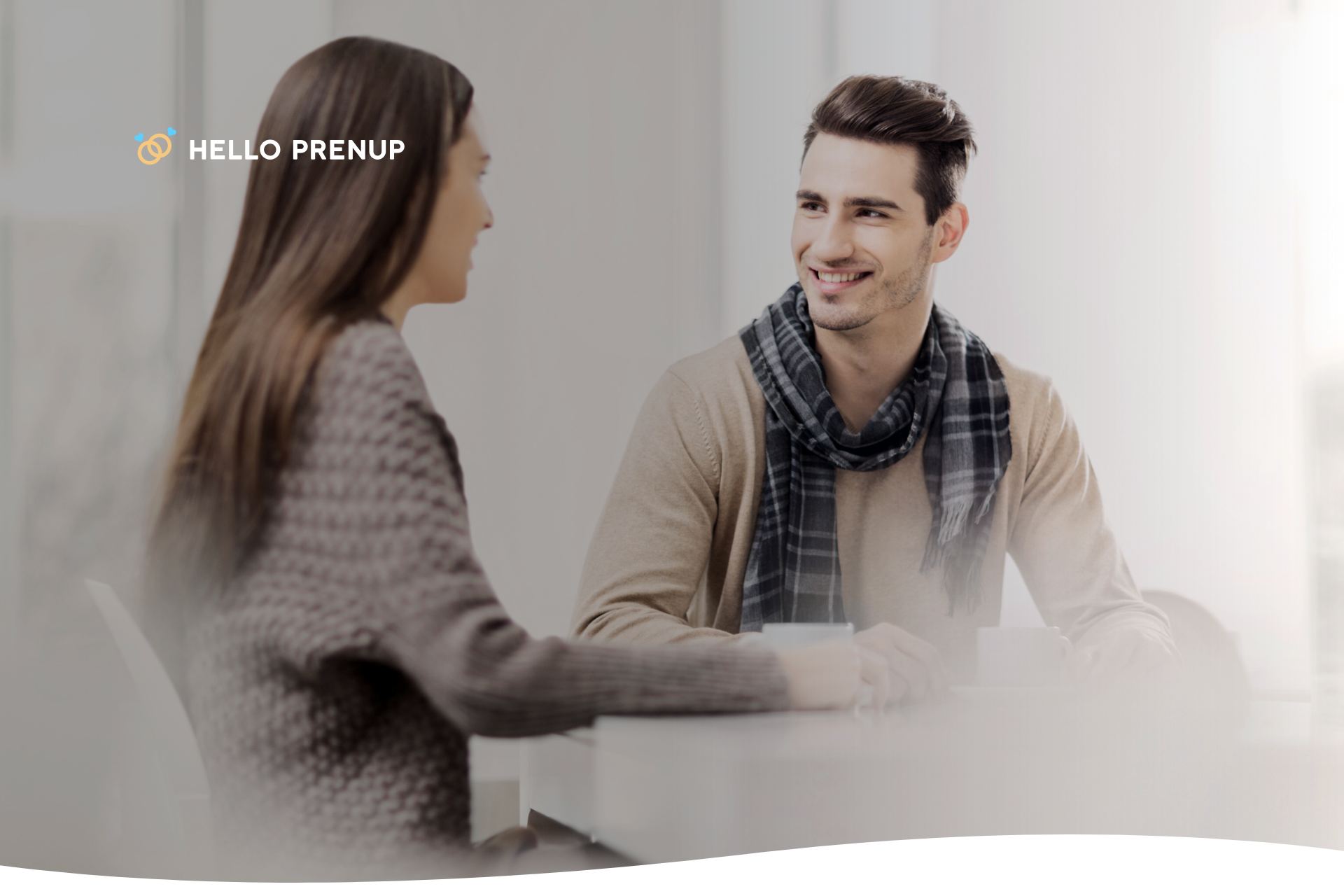 A couple sitting together, smiling and talking peacefully, representing a healthy conversation.