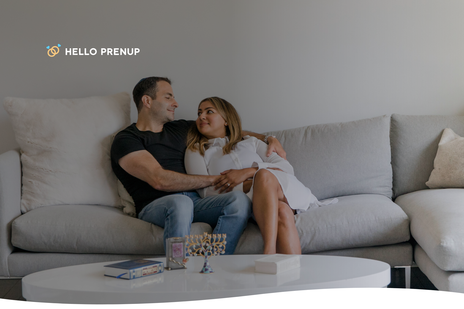 A couple sitting on a couch, engaged in a thoughtful and serious discussion, symbolizing emotional honesty.