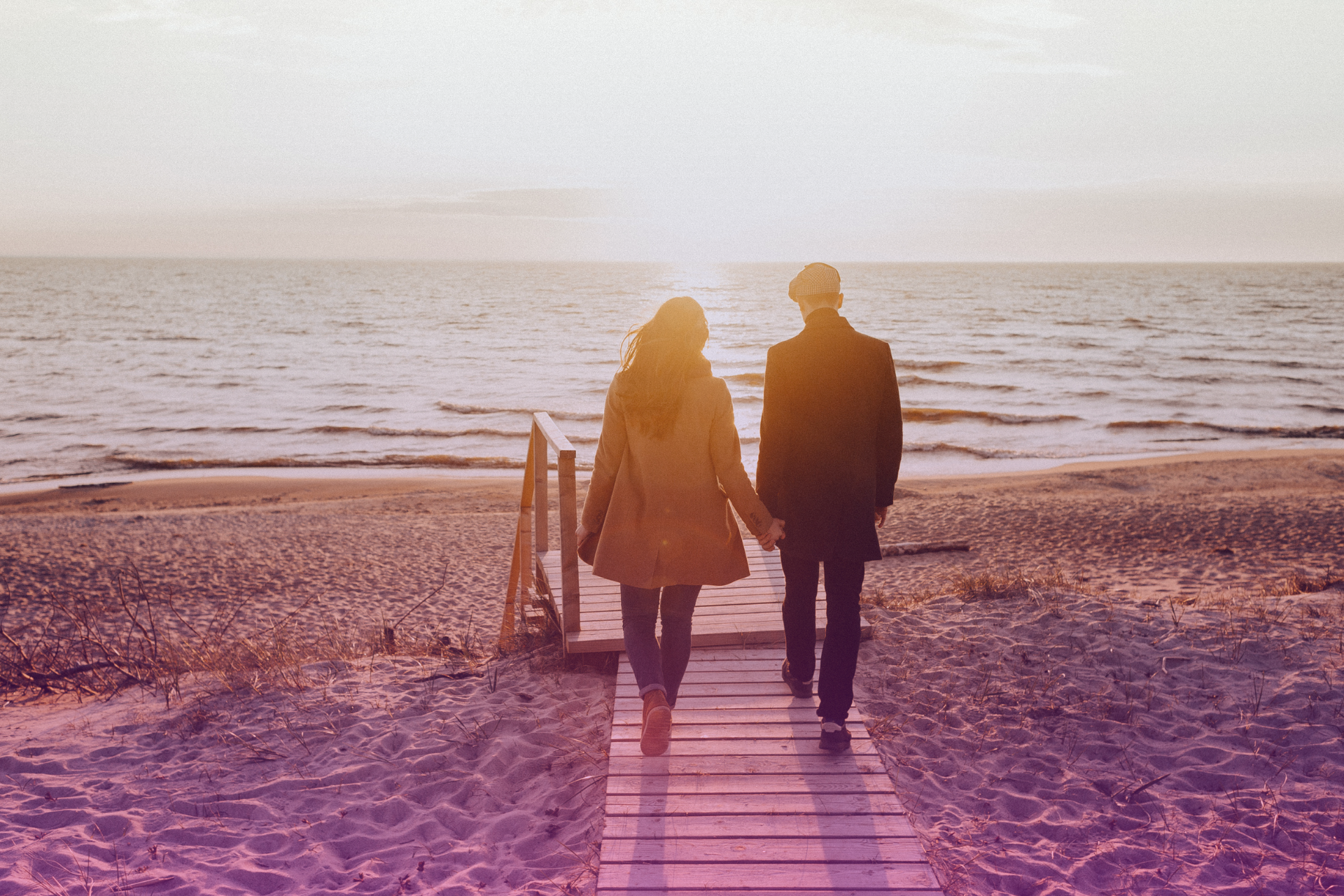 A couple walking slowly together through a light mist or fog, symbolizing navigating unseen challenges or emotional complexities with care.