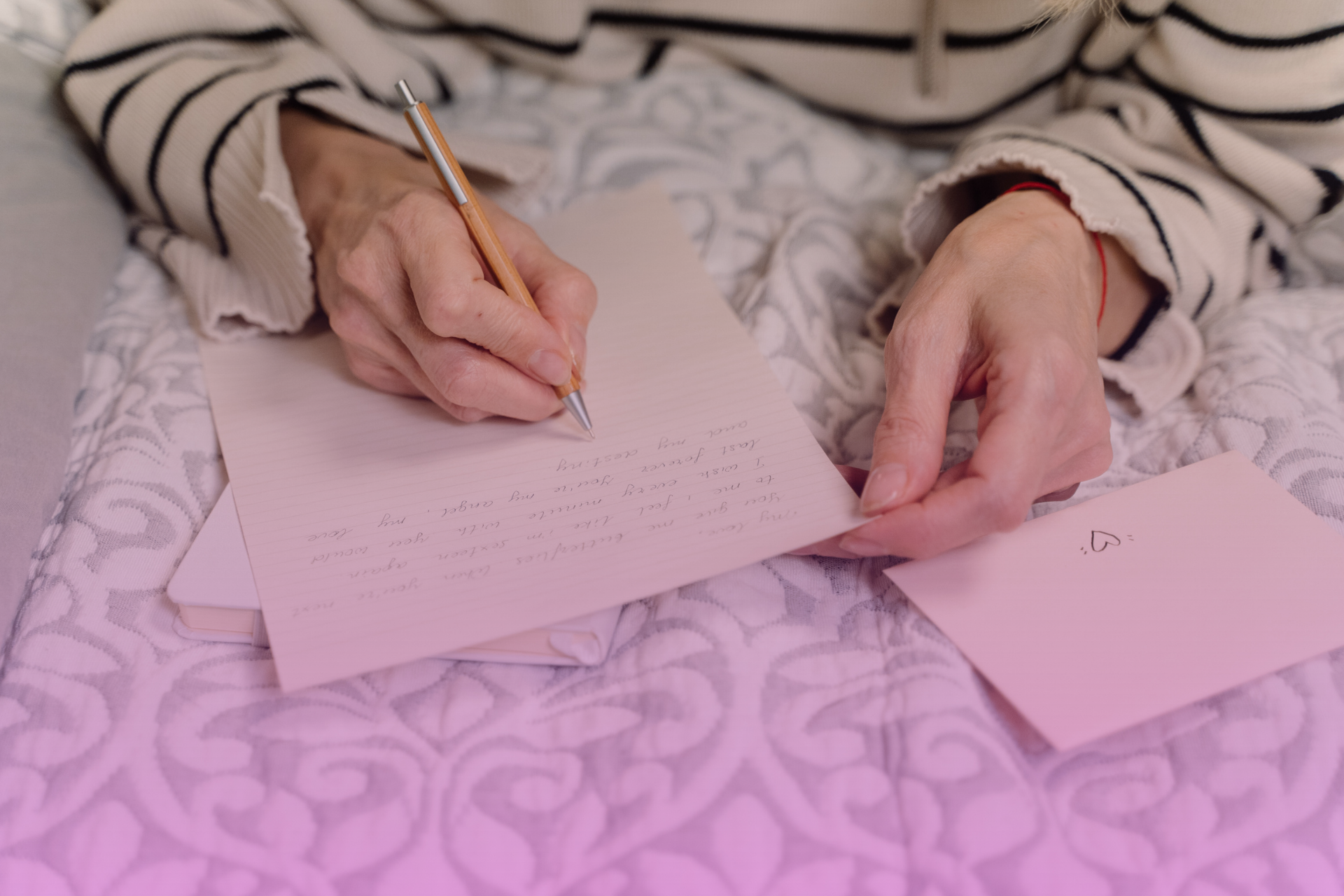 A vintage handwritten letter with a feather pen, evoking the personal and thoughtful nature of an ethical will.