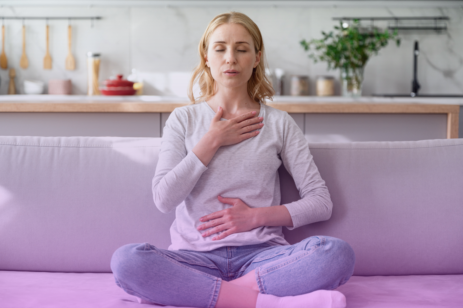 A person closing their eyes and taking a deep, calming breath, symbolizing pausing before reacting to criticism.