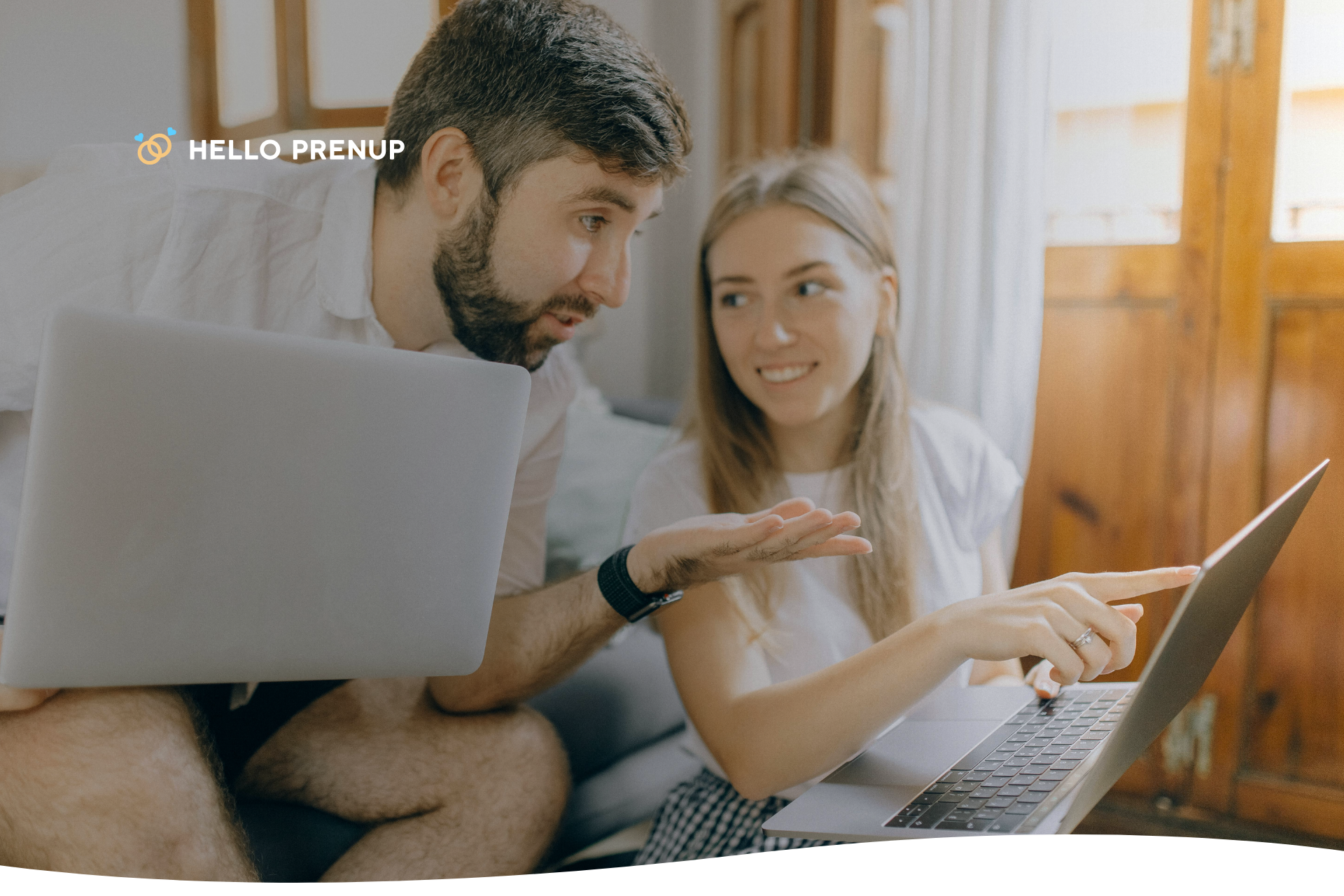 A couple sitting on a couch, each engrossed in their separate laptops with expressions of stress, symbolizing work consuming their shared time.