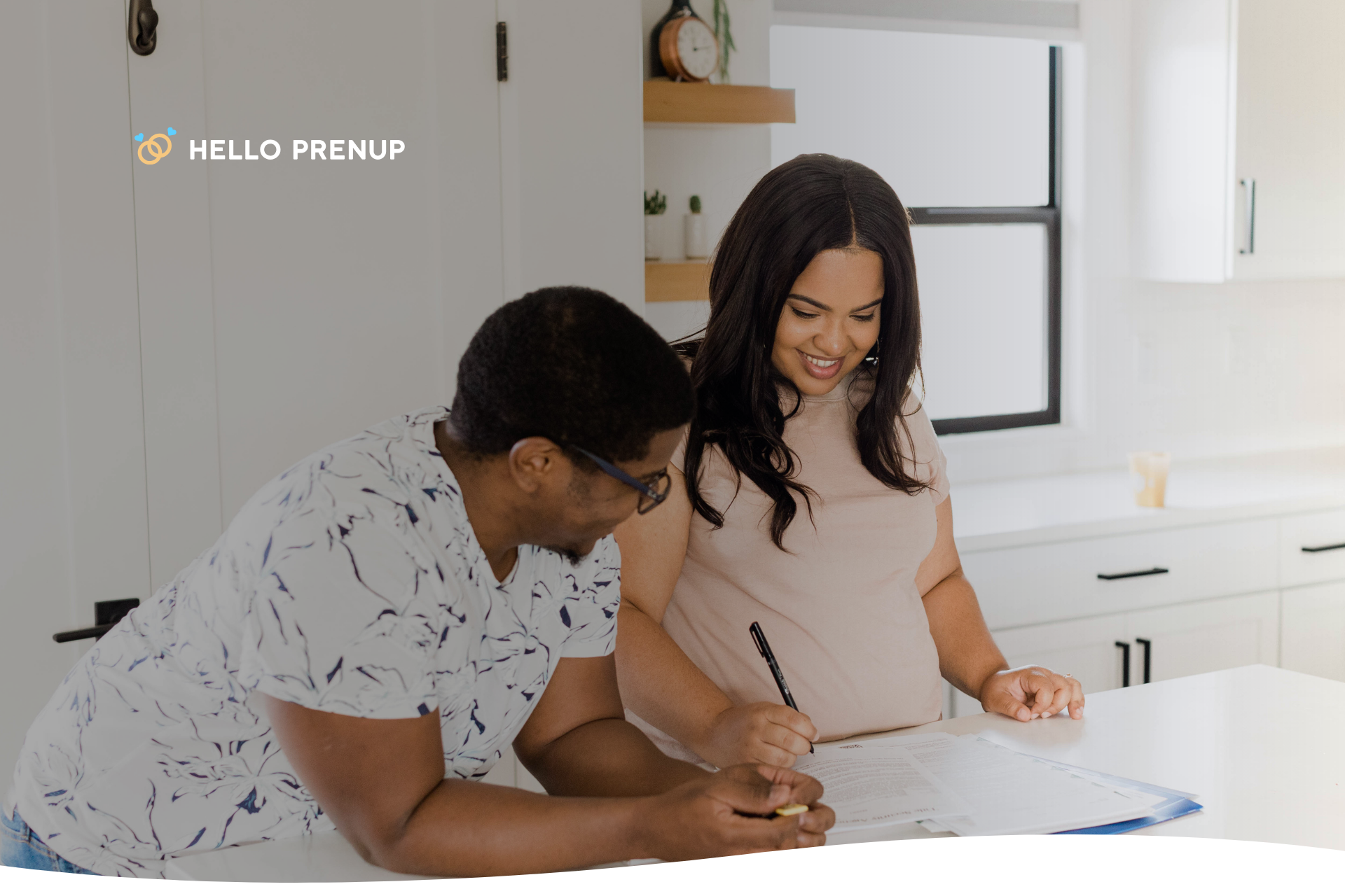A couple smiling and signing a new legal document together, symbolizing mutual agreement to revoke a previous prenup.