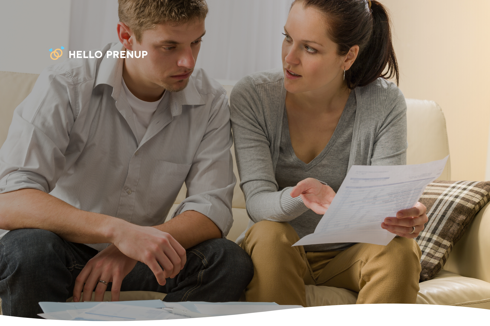 A couple sitting together calmly at a table, discussing financial documents without any tension.