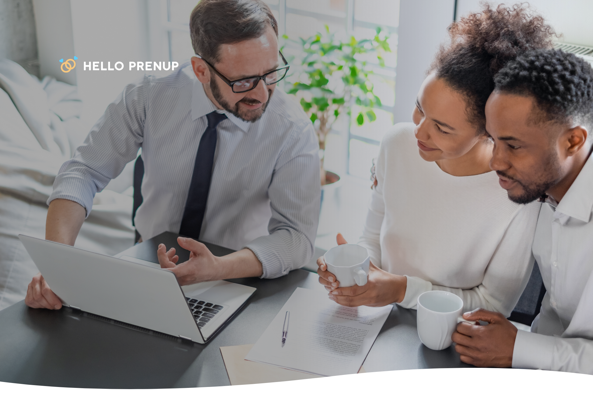 A couple sitting with a professional, a translator, and a lawyer, who are helping them understand their prenuptial agreement.