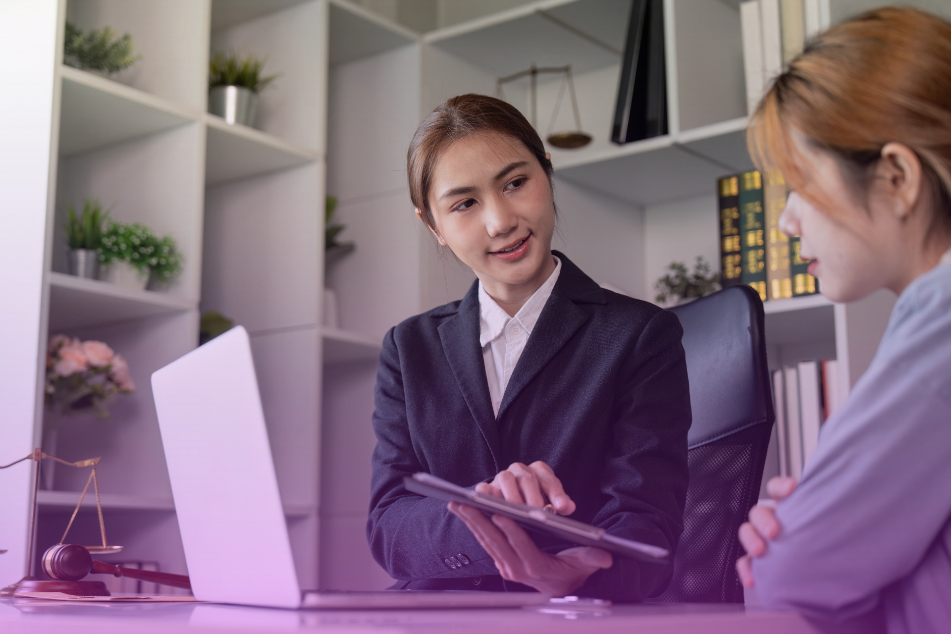 A lawyer pointing to specific sections of a complex legal document while a couple listens intently, symbolizing the guidance needed to understand both a trust and a prenup.