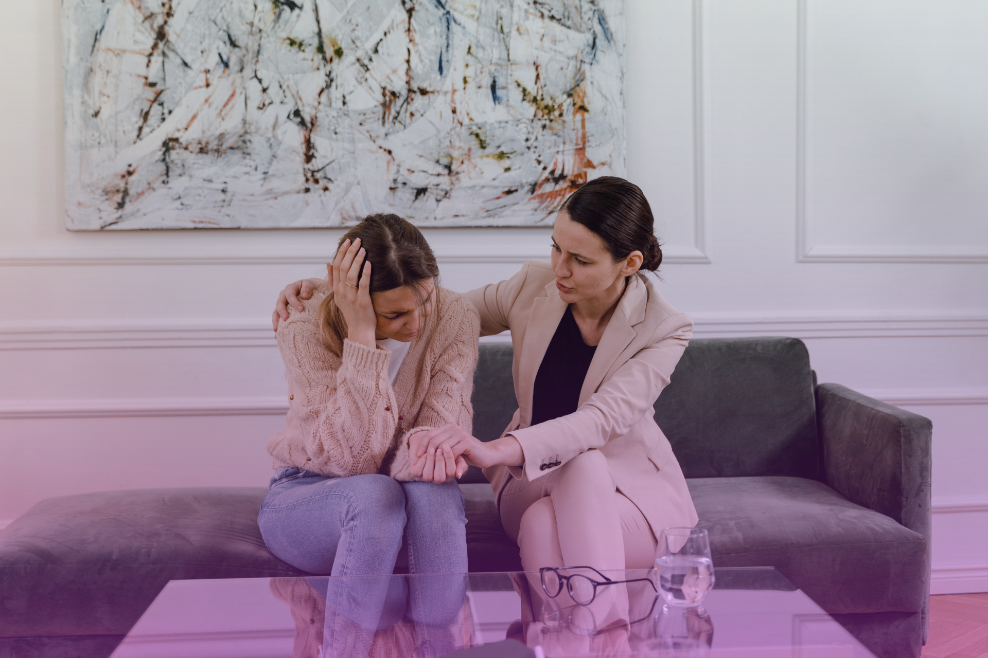 A person looking sad and withdrawn while their partner gently offers a comforting hand, symbolizing empathetic support during a struggle with depression.