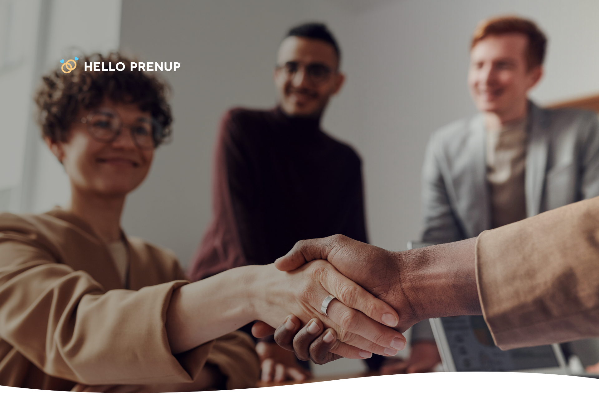 Two individuals with a firm handshake over a signed legal document, indicating a mutually agreed-upon and properly executed prenup.