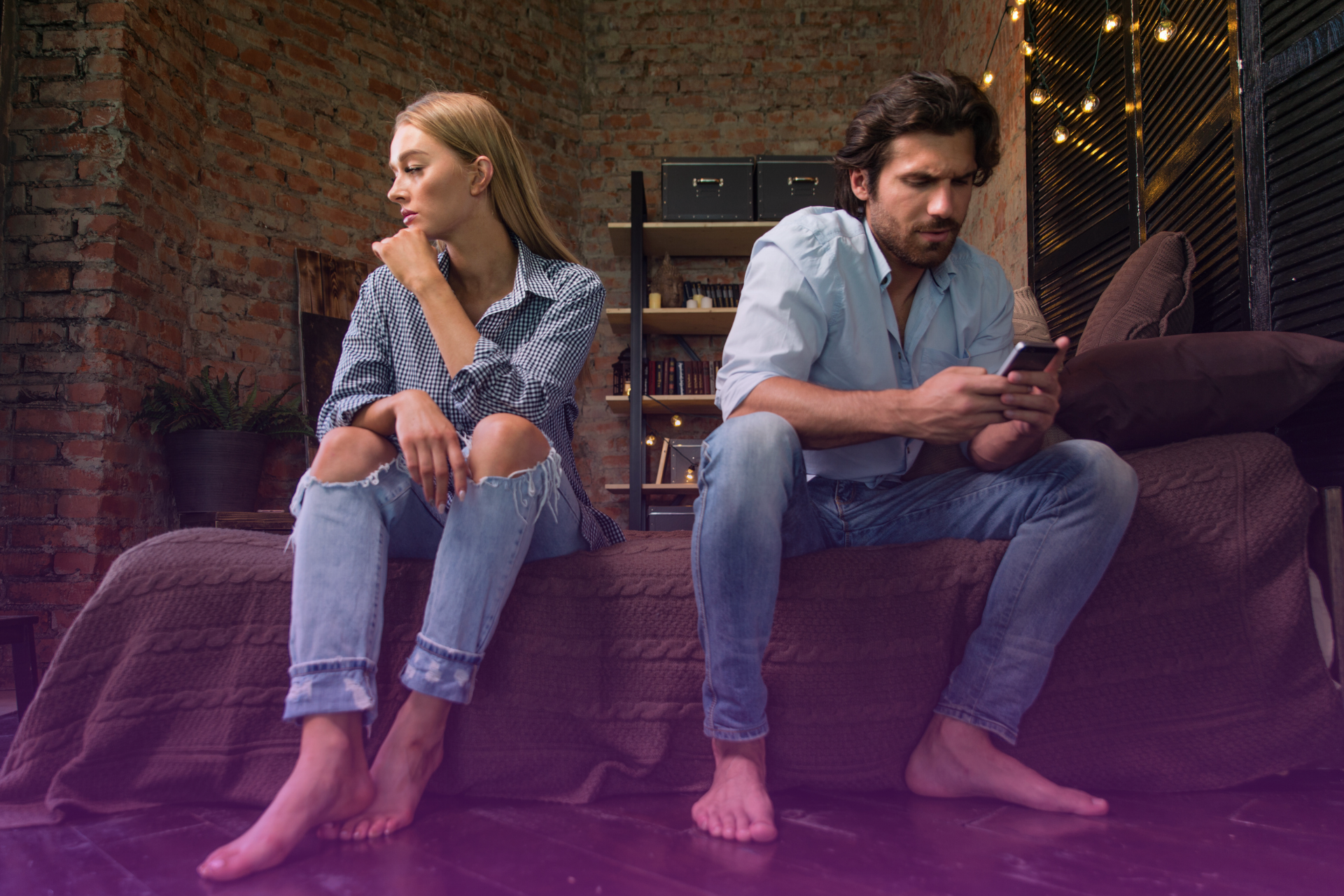 A woman looking visibly hurt and sad, with her partner looking away, symbolizing the pain of emotional distance caused by distrust.