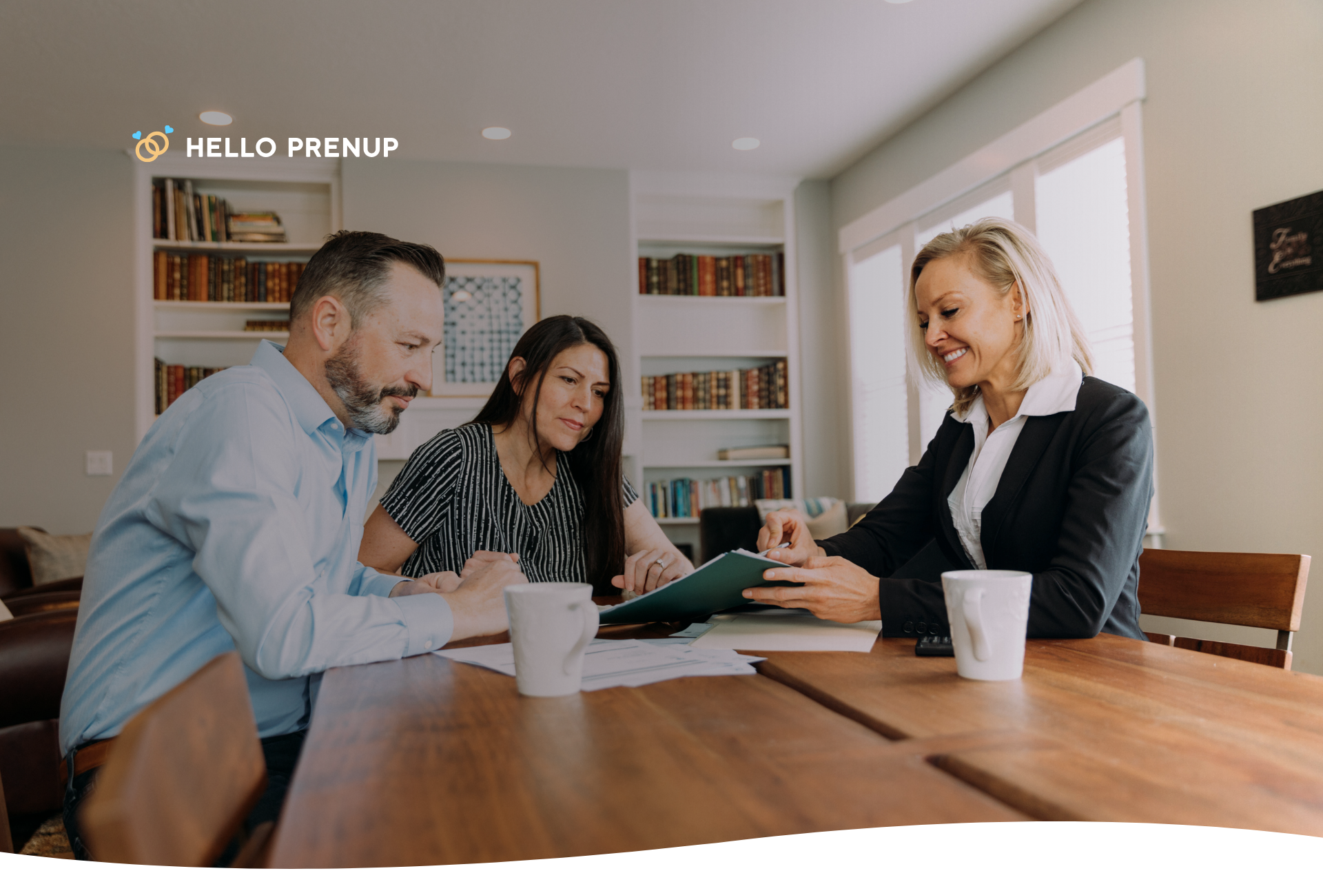 A couple sits with a financial advisor or attorney, having a professional and serious discussion about the cost of their prenuptial agreement.