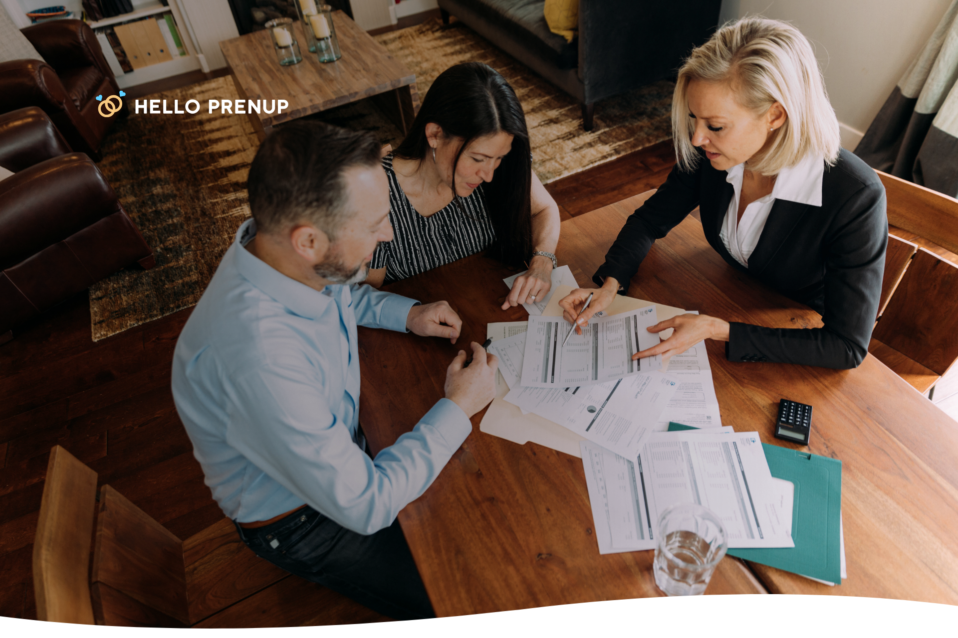 A couple sits with a financial advisor or attorney, having a professional and serious discussion about the cost of their prenuptial agreement.