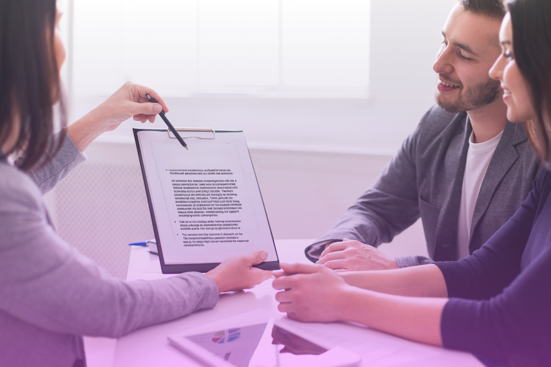 couple looks at a complex financial chart with a financial advisor, representing the need for professional guidance on taxes and trusts.