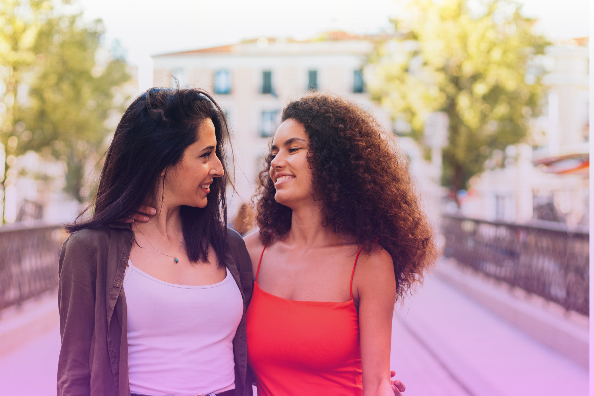 A couple smiles and holds hands while walking together, representing a stronger, more resilient relationship that has navigated conflict.