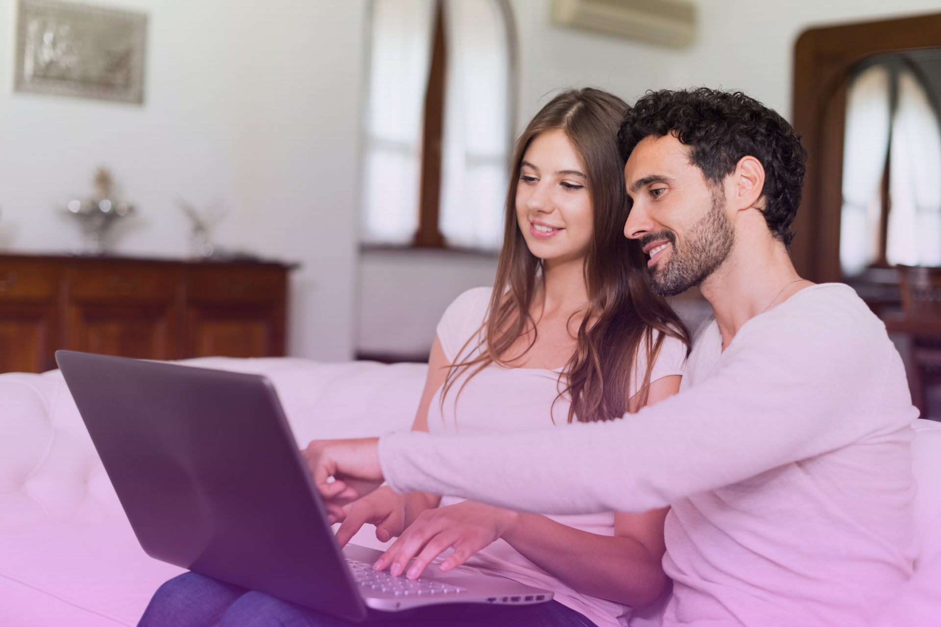 A couple uses a laptop together, symbolizing the collaborative and cost-effective nature of using an online service to begin their prenup.