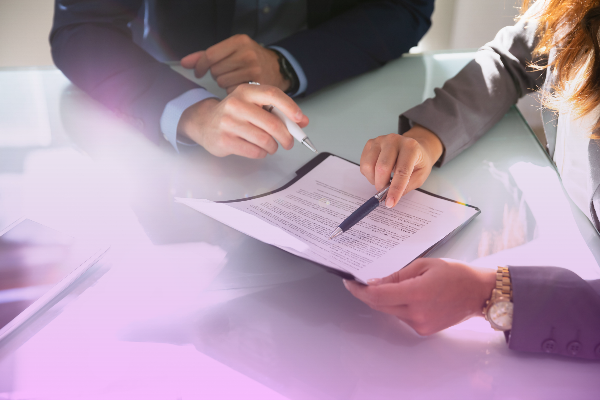 A person holds up two pieces of paper, one for a prenup and one for a trust, representing the complementary nature of the two legal tools.
