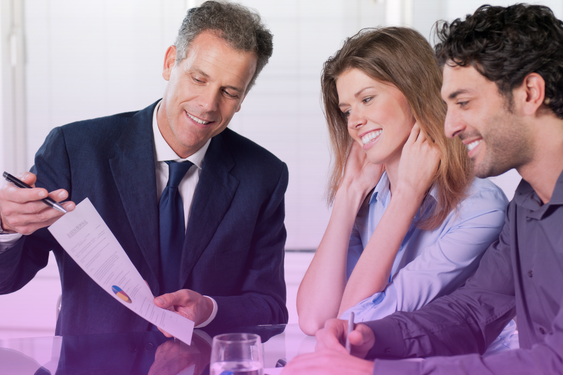 A couple looks at a financial plan with a sense of clarity and relief, representing the positive outcome of a transparent and empathetic process.