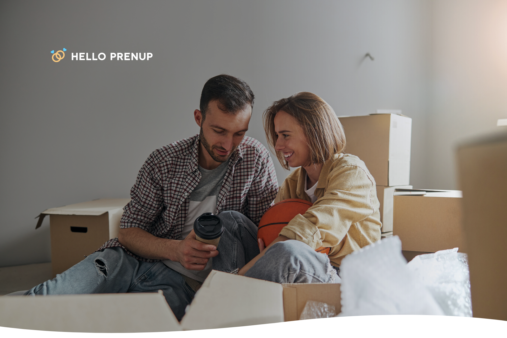 A couple sits on the floor surrounded by half-unpacked boxes, eating takeout and laughing, symbolizing the importance of finding humor and connection amidst the chaos.