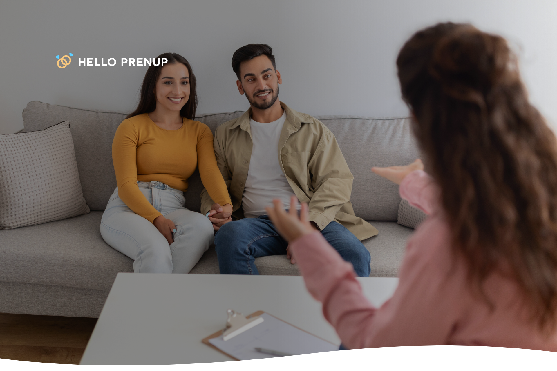 A couple sits in a therapy session, both actively engaged in conversation, symbolizing the commitment to professional help to navigate complex emotions.