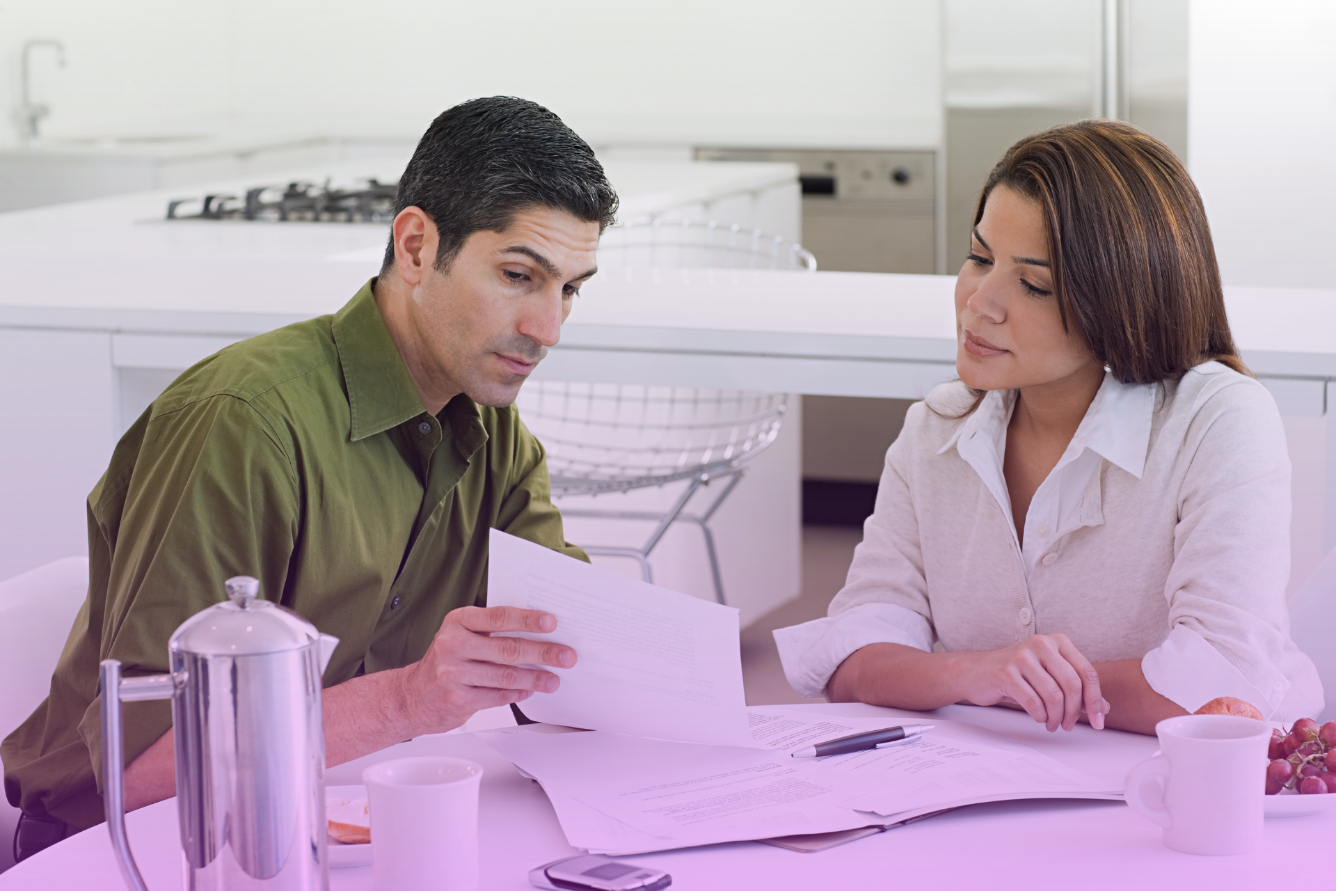 A couple looks at a detailed checklist for transferring assets into a trust, representing the attorney's role in guiding the complex "funding" process.