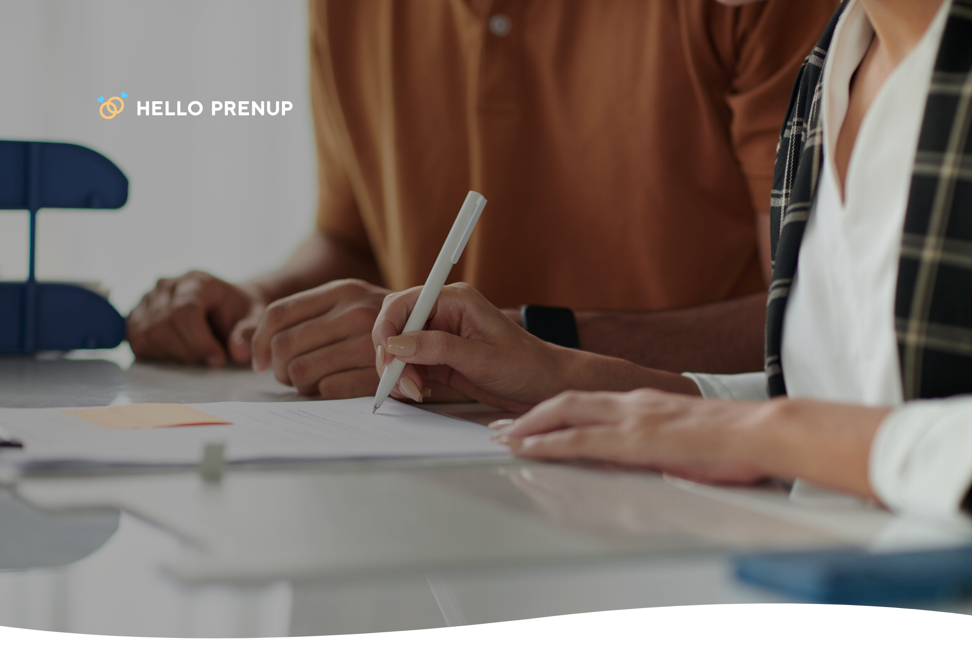 A woman and man collaboratively reviewing a prenuptial agreement on a laptop, focusing on the spousal support section.