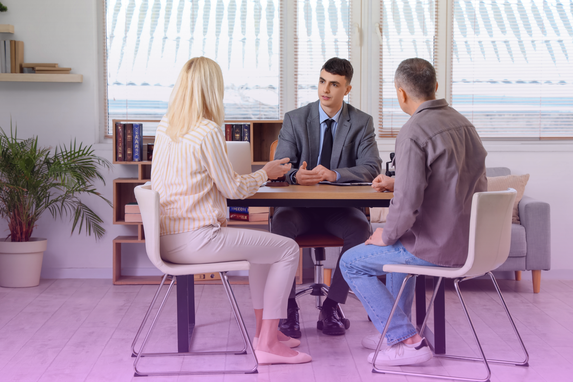 Couple meeting with a lawyer to discuss a prenuptial agreement before marriage