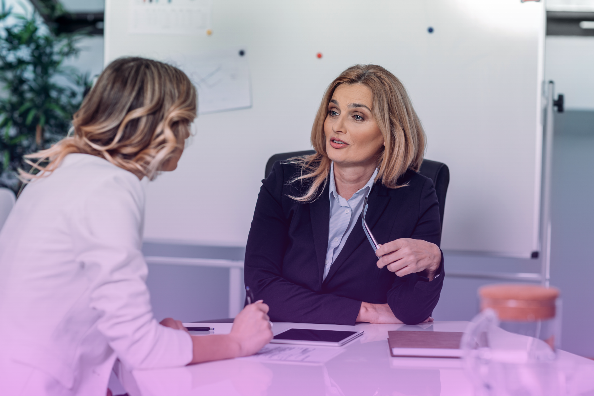 A woman looking confident while signing documents for her revocable trust and pour-over will on a secure desktop.