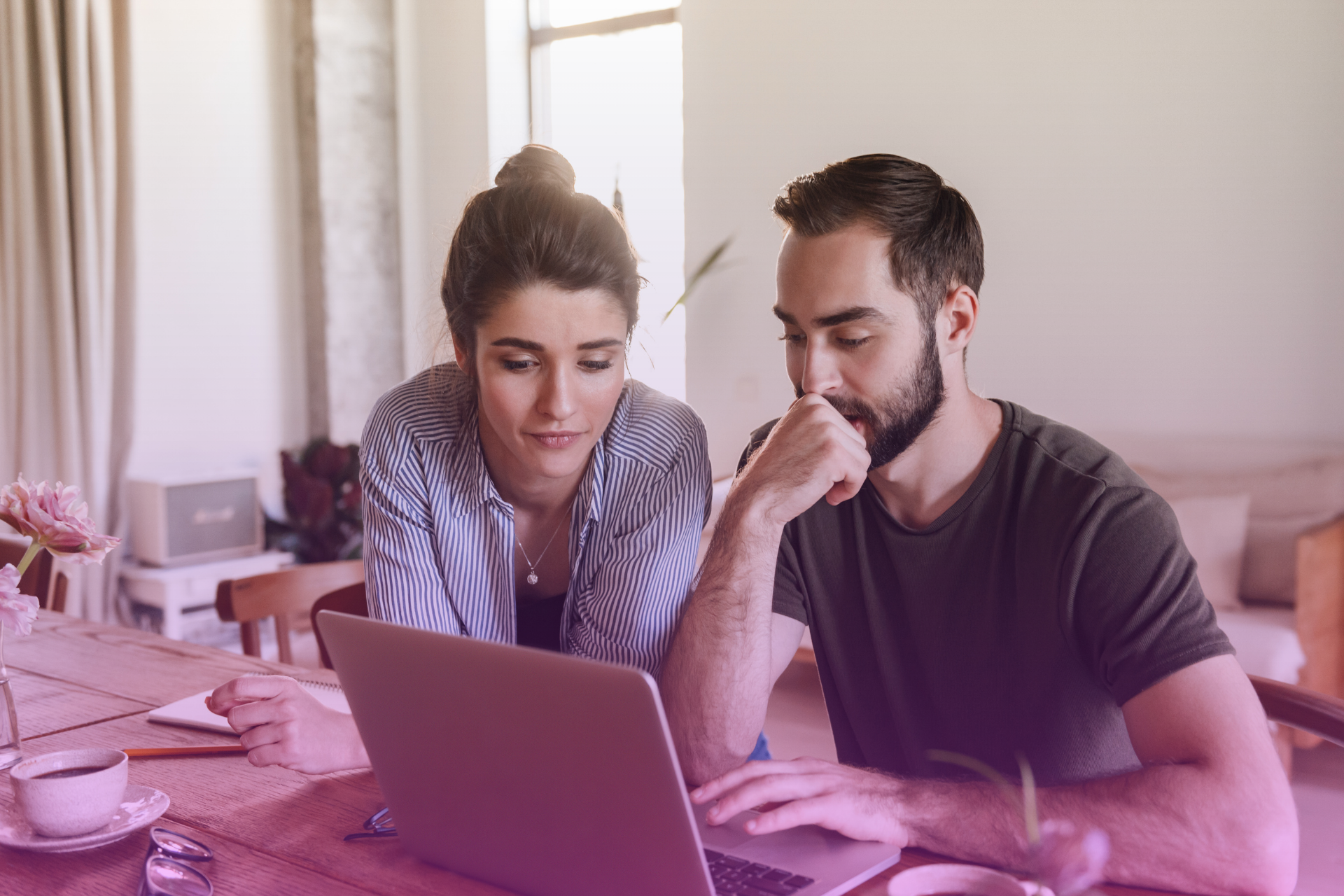 A happily married couple reviewing financial documents, demonstrating open communication about their postnup.