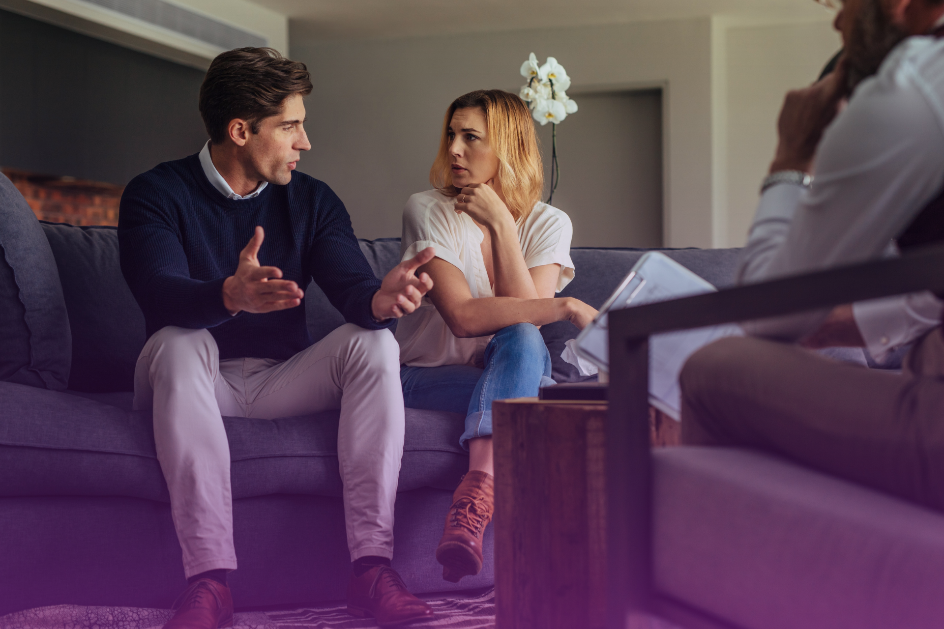 Couple in therapy session discussing financial stress and relationship impact