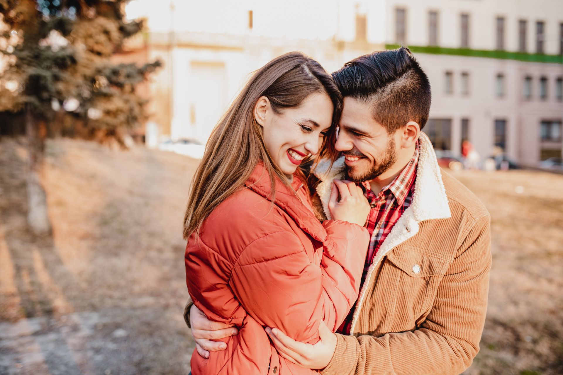 A couple in love, embracing and laughing together on an autumn day