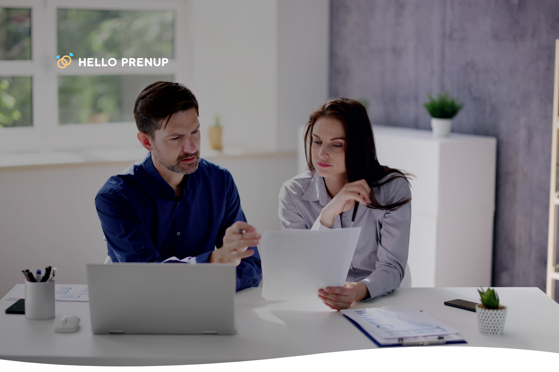 couple-reviewing-prenup-agreement-in-raleigh Overhead shot of a tablet showing the HelloPrenup platform next to a printed North Carolina legal document and a pen.
