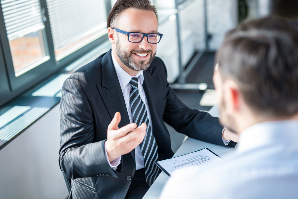 A man having a conversation with his attorney during a legal consultation