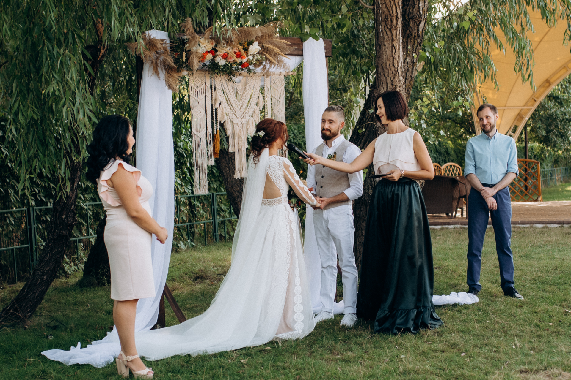 Intimate outdoor wedding with close family and friends A small outdoor wedding ceremony attended by close family and friends, gathered together in an intimate and heartfelt celebration