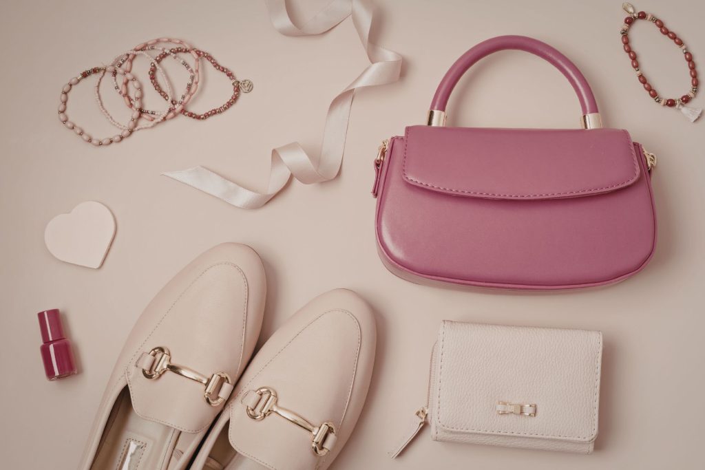 A bag with comfortable shoes and makeup items arranged together, showing essential items a bride may bring for her wedding day