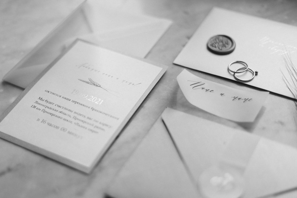 A close-up of wedding invitations showcasing refined paper textures, stylish fonts, and decorative elements arranged for display