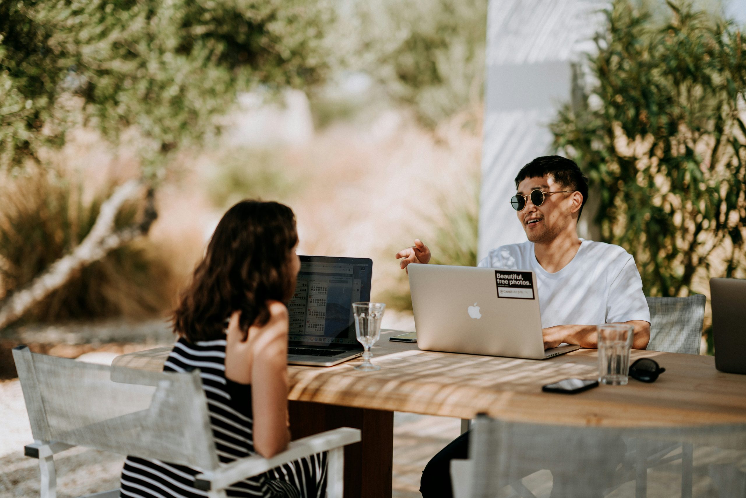 Couple completing agreement on laptops