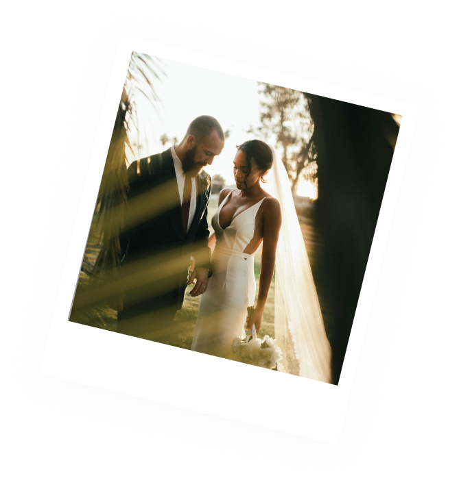 Polaroid photo of a bride and groom walking together at sunset