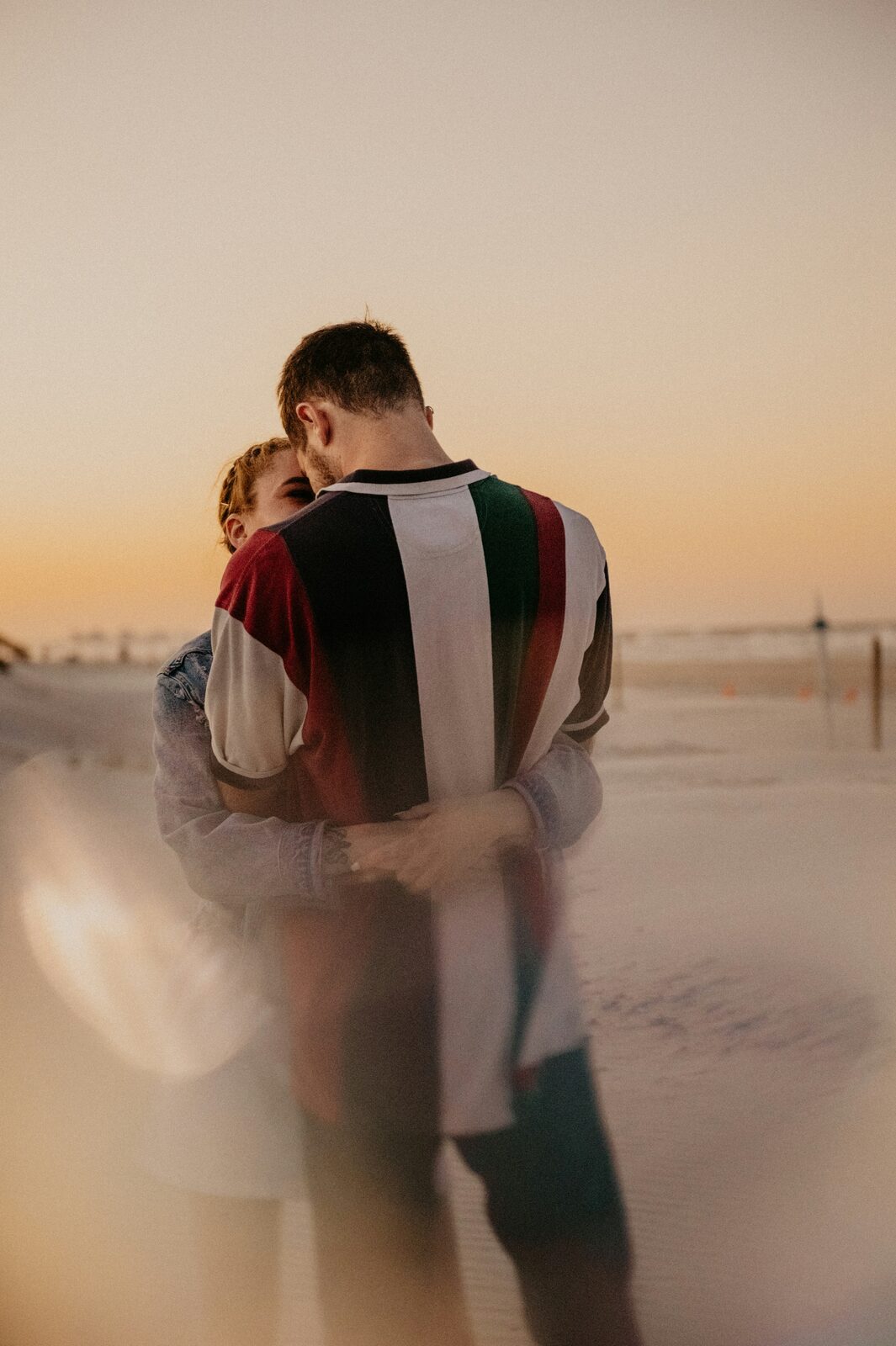 Florida couple embracing on the beach at sunset after a stress-free prenup process