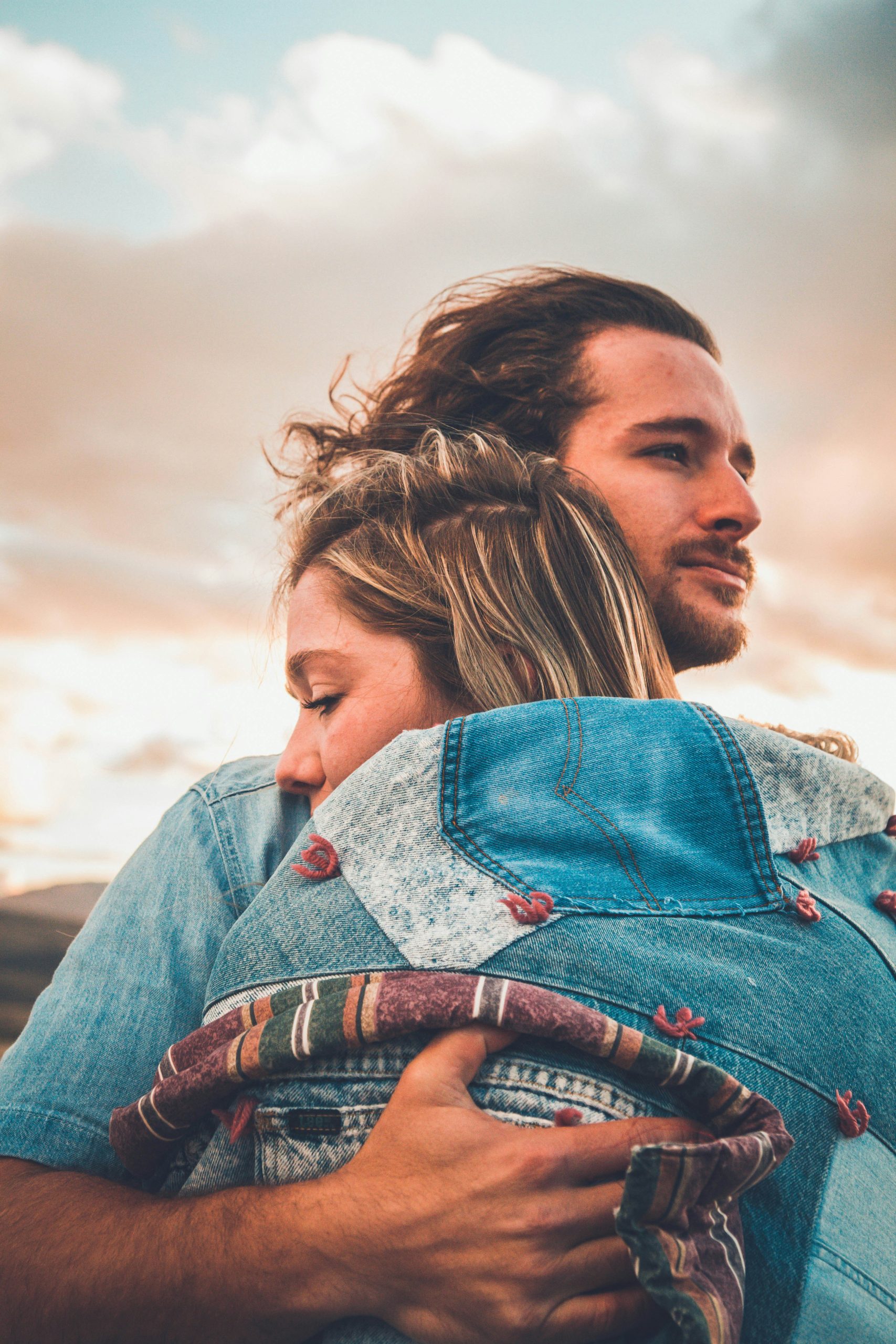Engaged Alabama couple hugging at sunset, ready to protect their future with a HelloPrenup prenuptial agreement