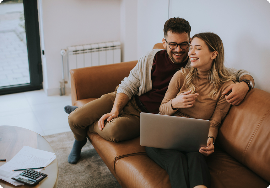 Alabama couple on the couch reviewing their prenup options on a laptop