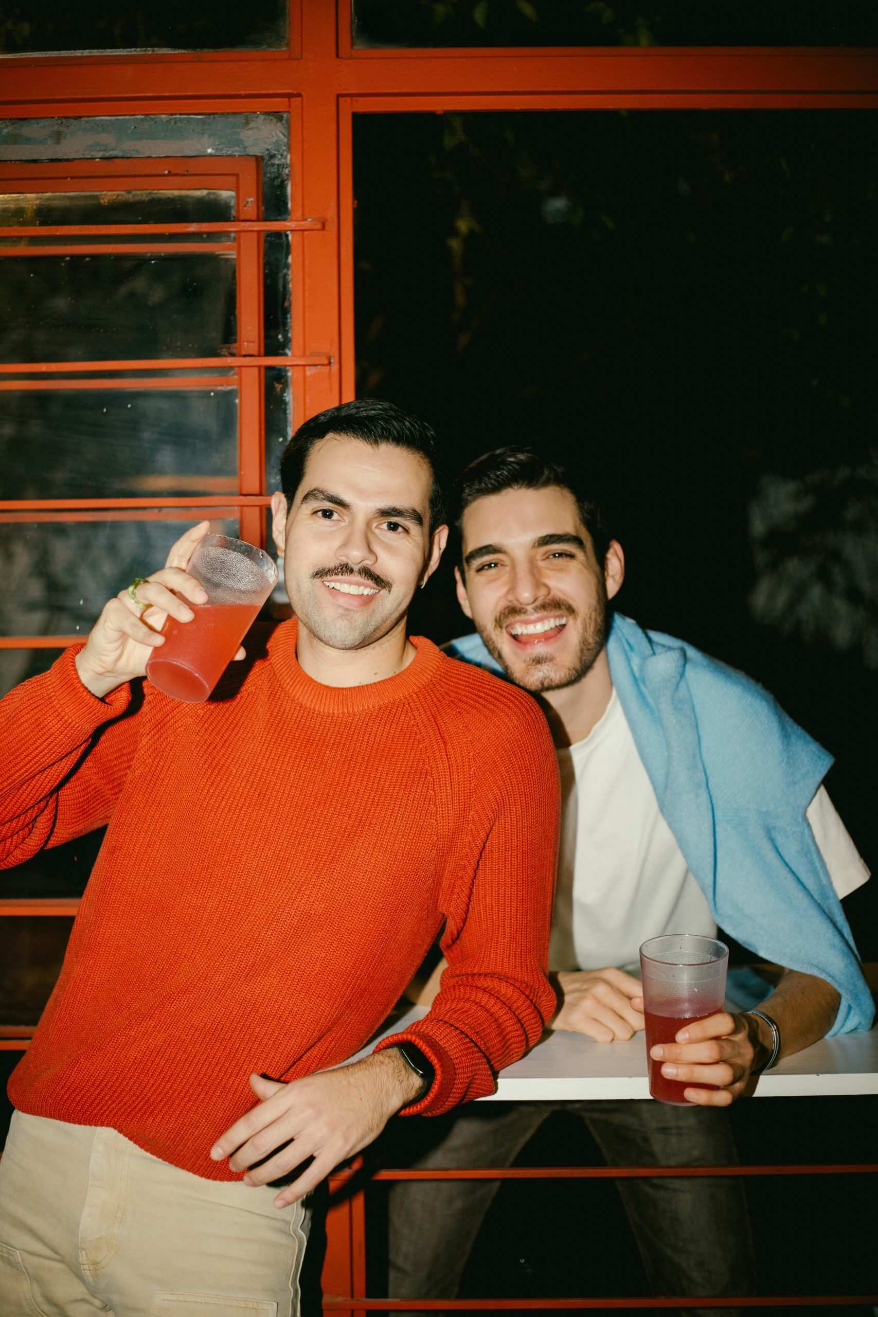 California couple celebrating with drinks after a stress-free prenup process