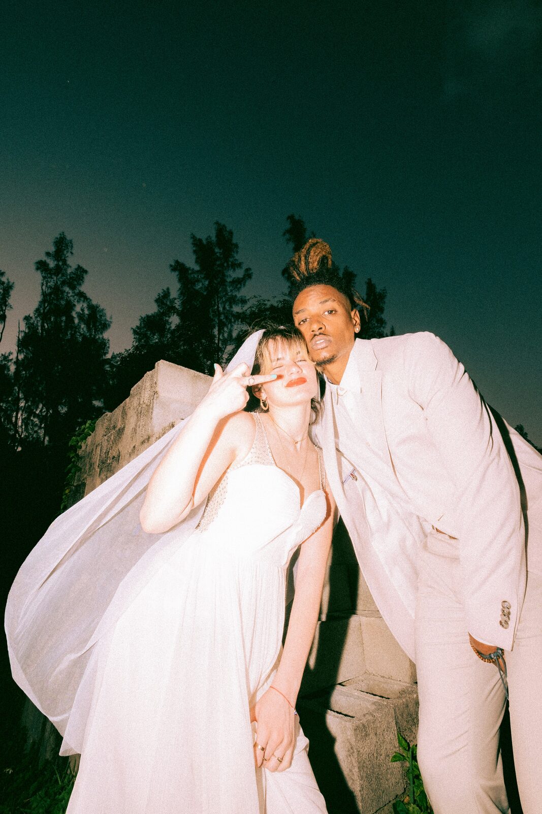 Florida newlyweds in a wedding portrait with the bride's veil flying, married with a HelloPrenup prenuptial agreement in place