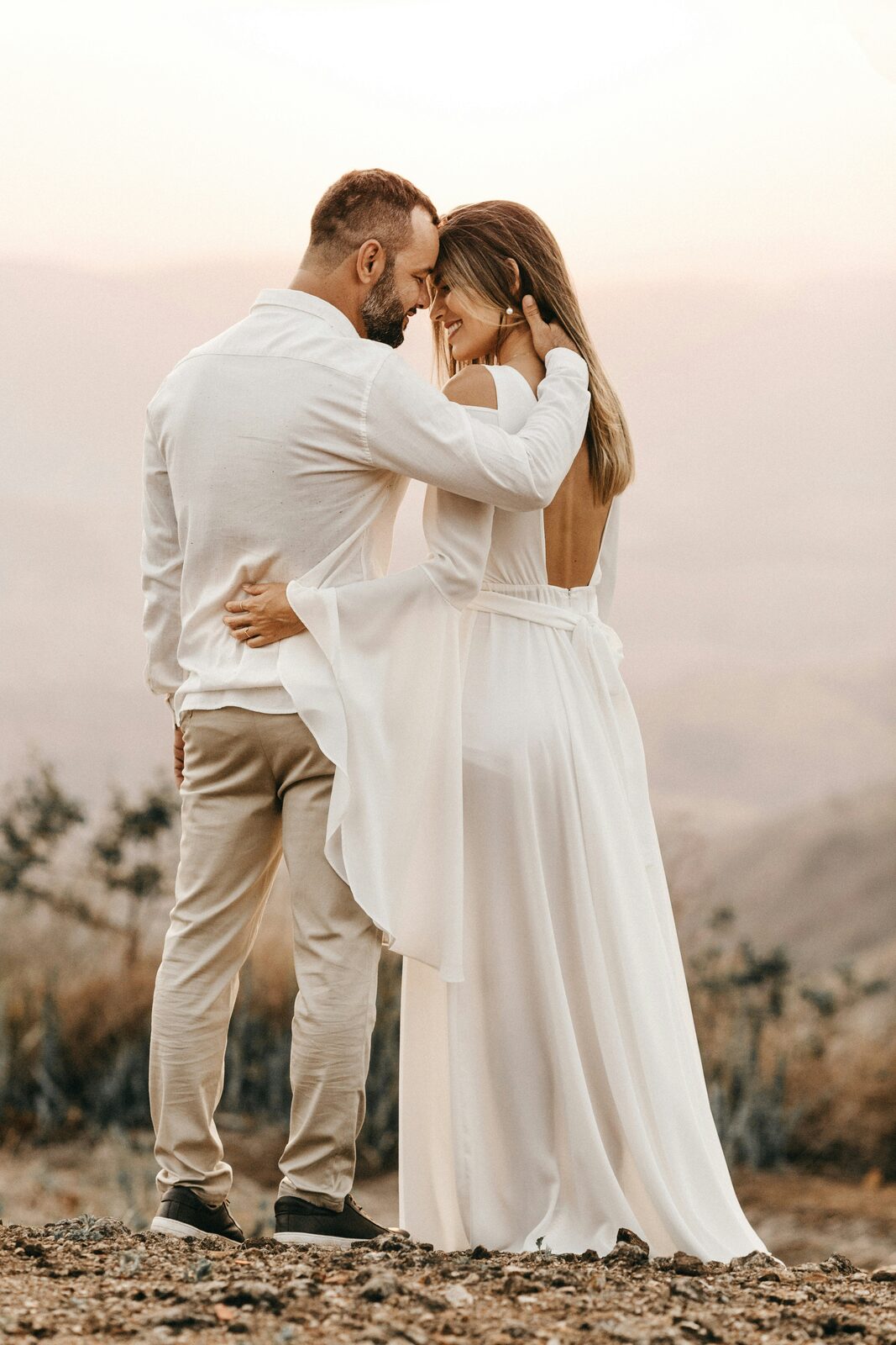 Massachusetts couple embracing at a mountain-top sunset wedding, protected with a HelloPrenup prenuptial agreement