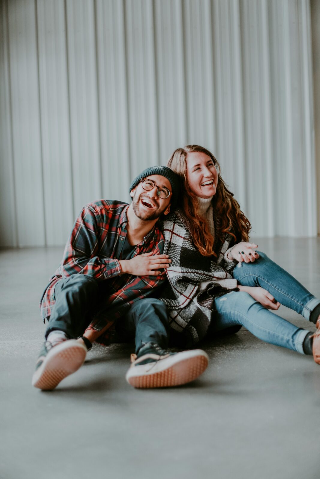 Married couple laughing together at home